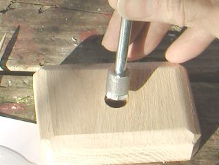 Insert screw head and bushing into wood block